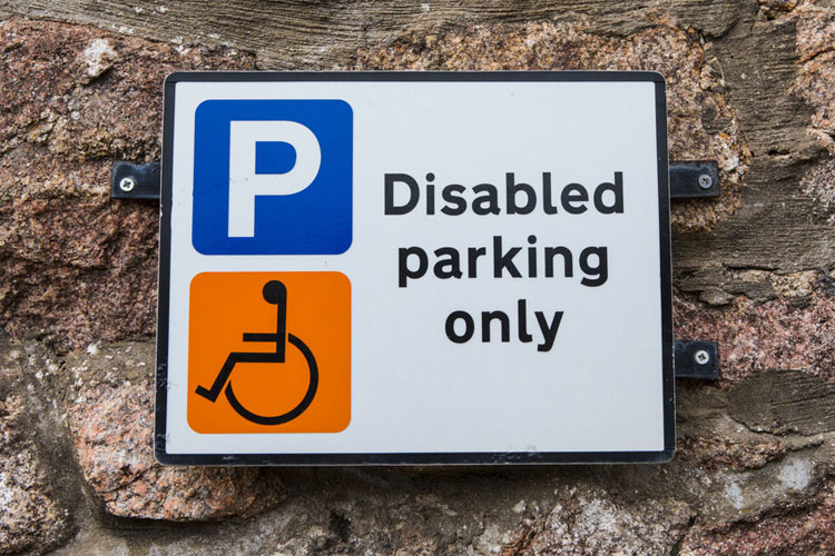Disabled badge holders only no parking sign Not every disability is visible 